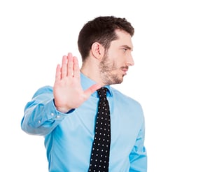 Closeup portrait of young handsome, grumpy man with bad attitude giving talk to hand gesture with palm outward, isolated white background. Negative emotions, facial expression feelings, body language.jpeg